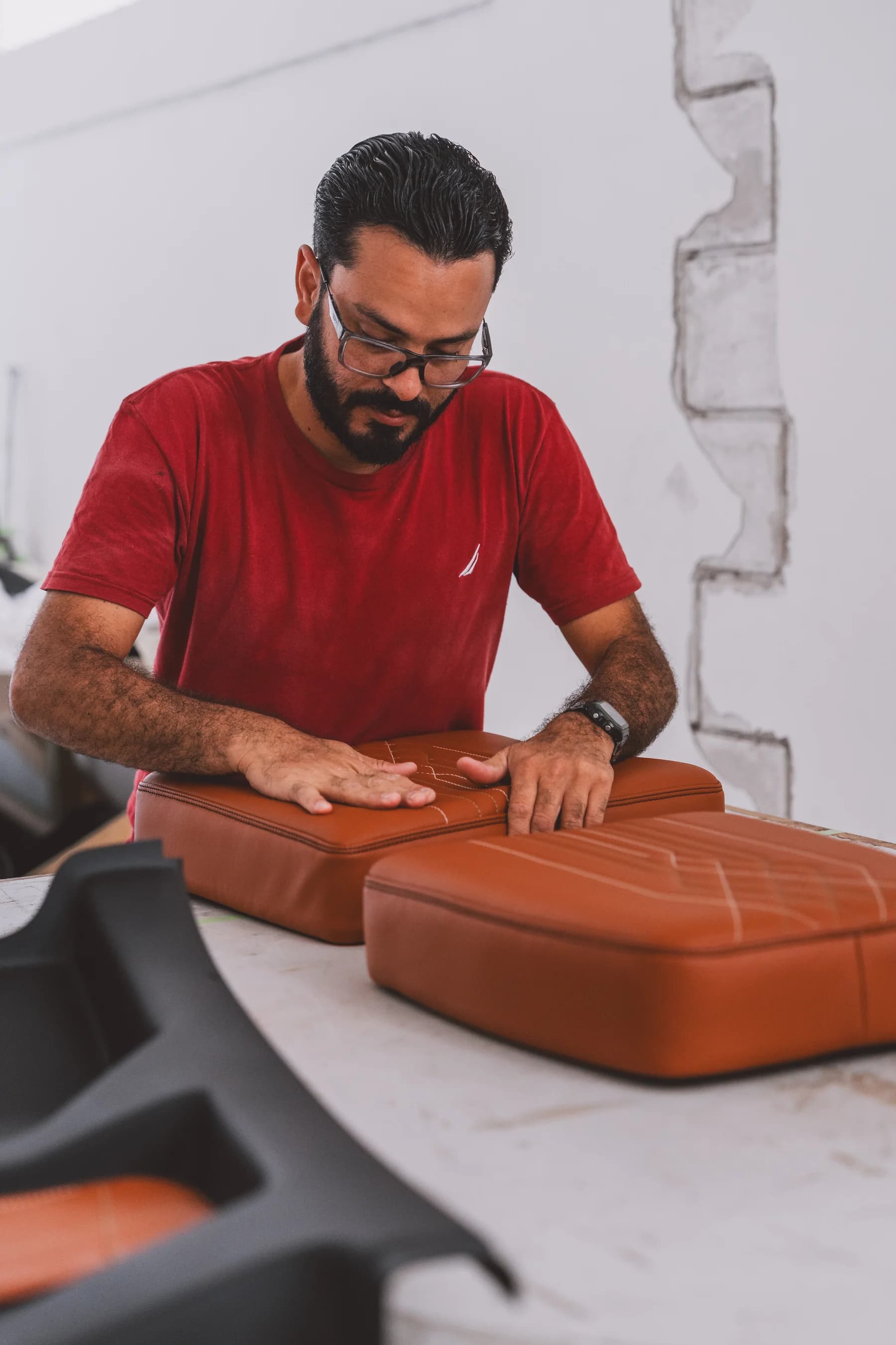 Aerocorp interior specialist hand-finishing a custom aircraft seat