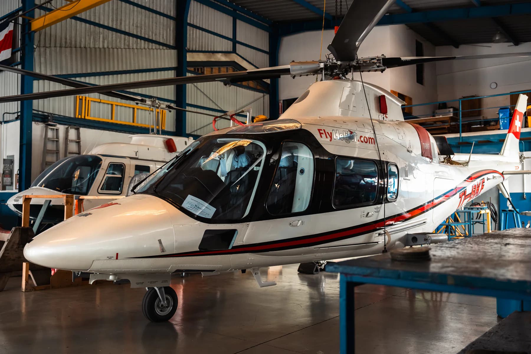 Helicopter receiving maintenance support inside the hangar